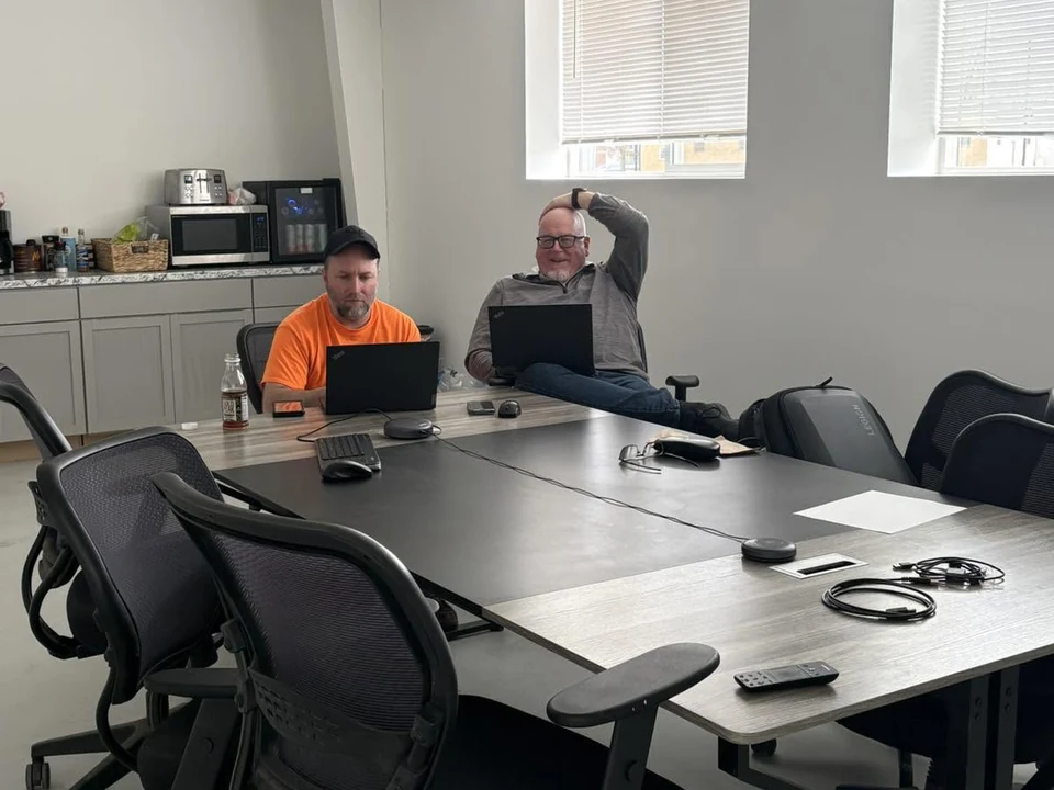 Jeff, owner of King Security Solutions, on a conference call at a meeting table